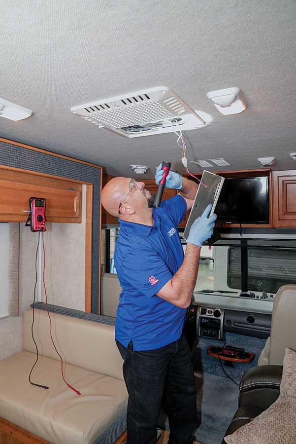 A technician checks the air conditioner A technician checks the air conditioner during a predelivery inspection