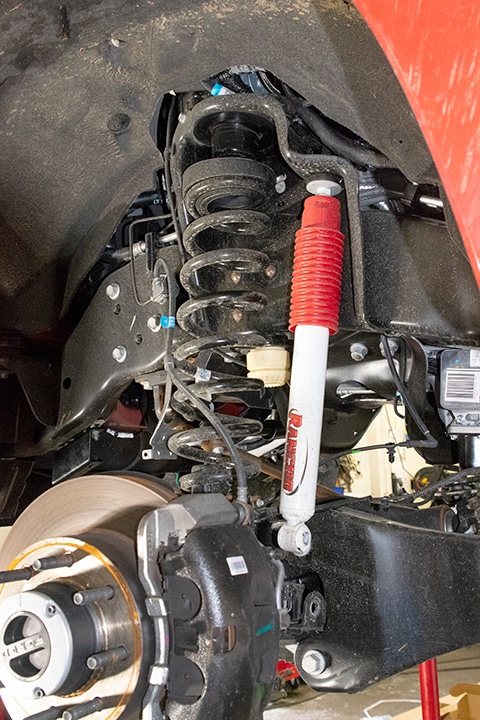 Heavy-duty front springs installed on a full-size pickup truck