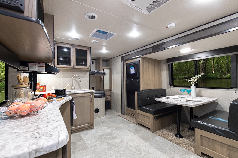 Looking toward the rear of the trailer toward the bunks, showing the kitchen and dinette.