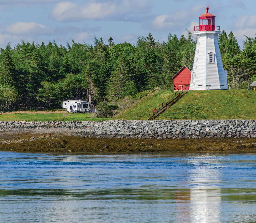 A fifth-wheel trailer parks near a lighthouse on New Brunswick’s Campobello Island, the second largest of the Fundy Islands.