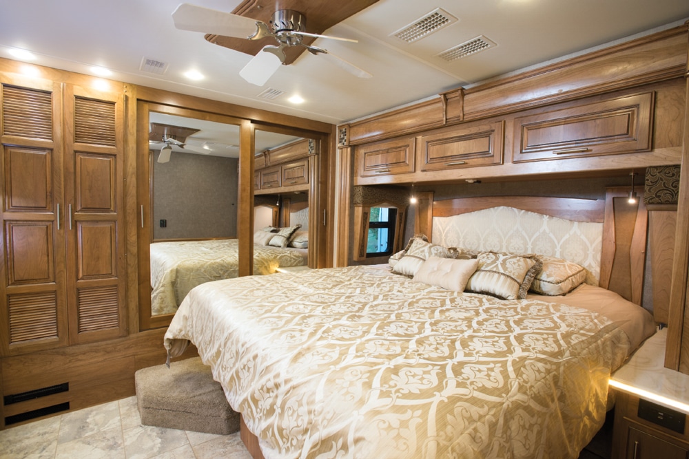 The king bed is housed in a streetside slideout in the master. Handy solid surfaces on each side are perfect for nightstand duties. A large closet runs the length of the back wall. 