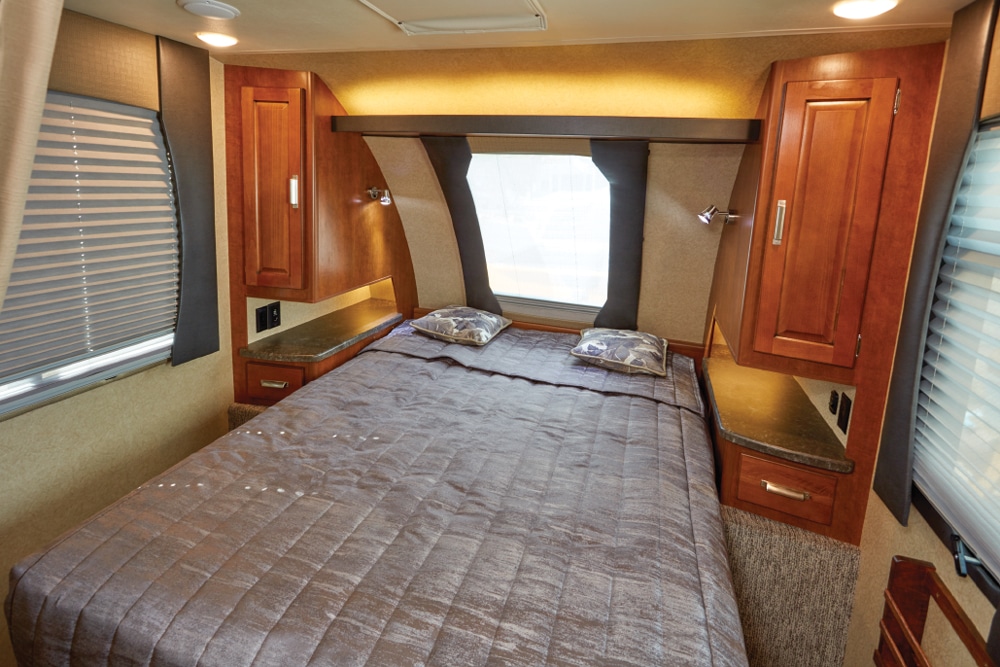 Wardrobe closets and built-in nightstands flank the cozy queen bed.