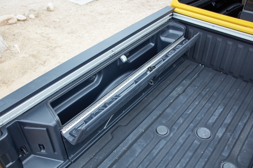 The truck bed is fitted with lockable storage boxes that can double as coolers, with drink holders.