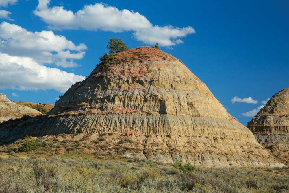 Badlands, like these near the Old East Entrance Station in the South Unit, are the result of softer sedimentary rocks and soil eroded by wind and water.