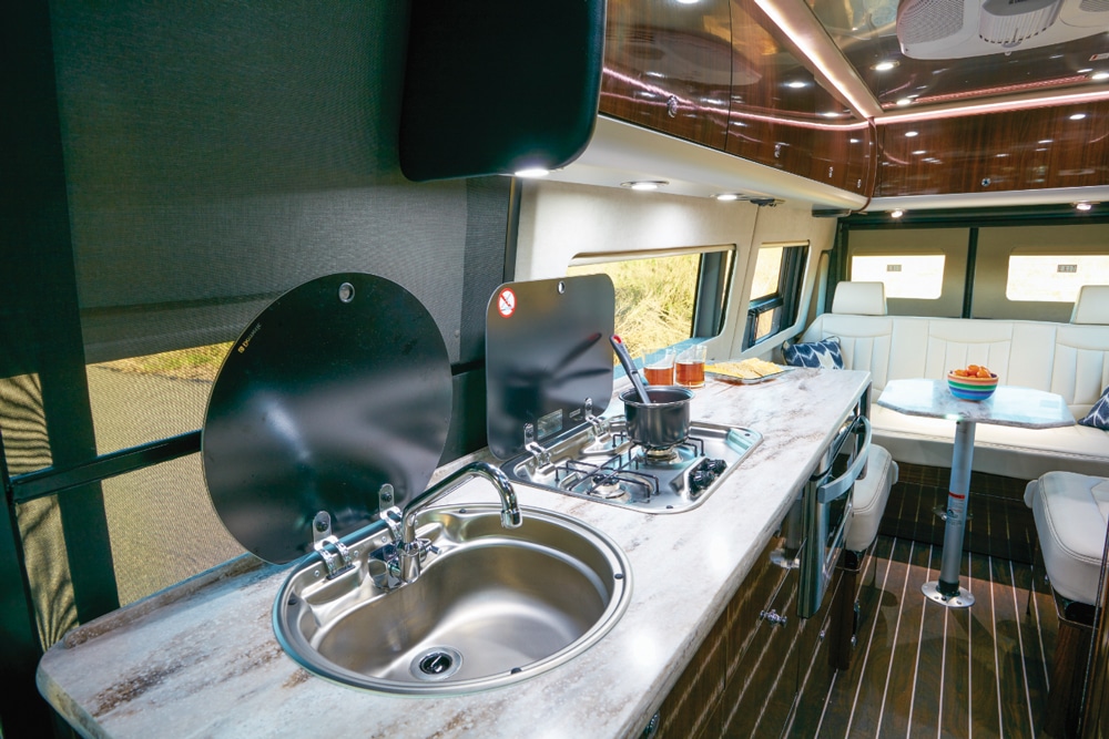 The galley is set up for convenience so the spacious upper and lower cabinets can be reached easily, along with the drawers, food pantry, refrigerator and unique undercounter microwave.