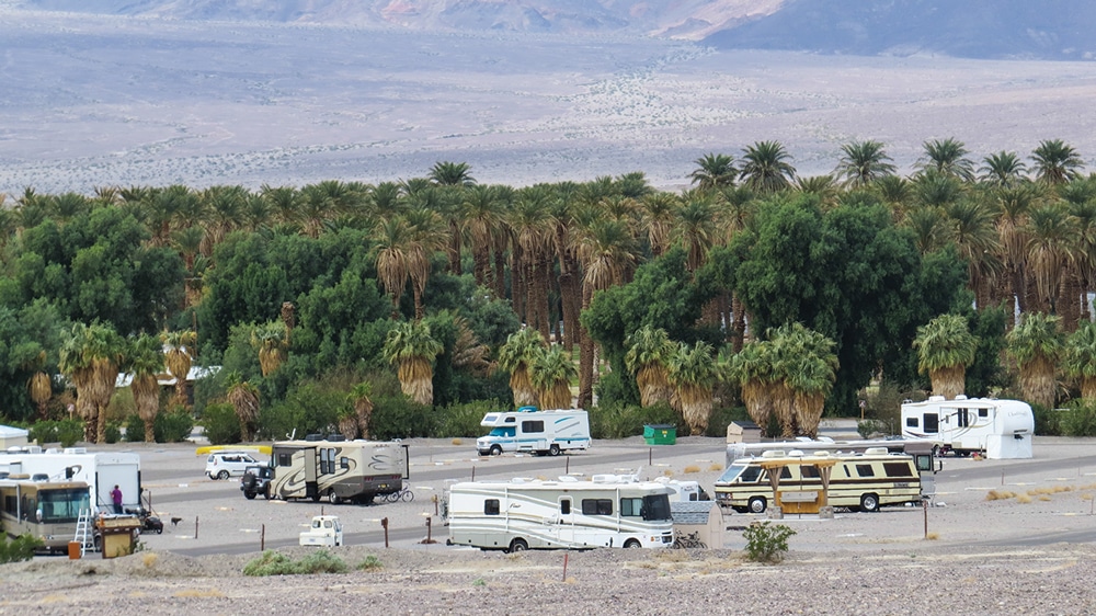 An overview of Sunset Campground with Furnace Creek Ranch’s date grove and valley floor in the background.