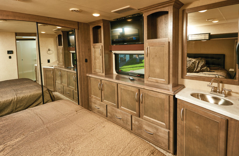 A king-size bed and a generous assortment of cabinets in RV