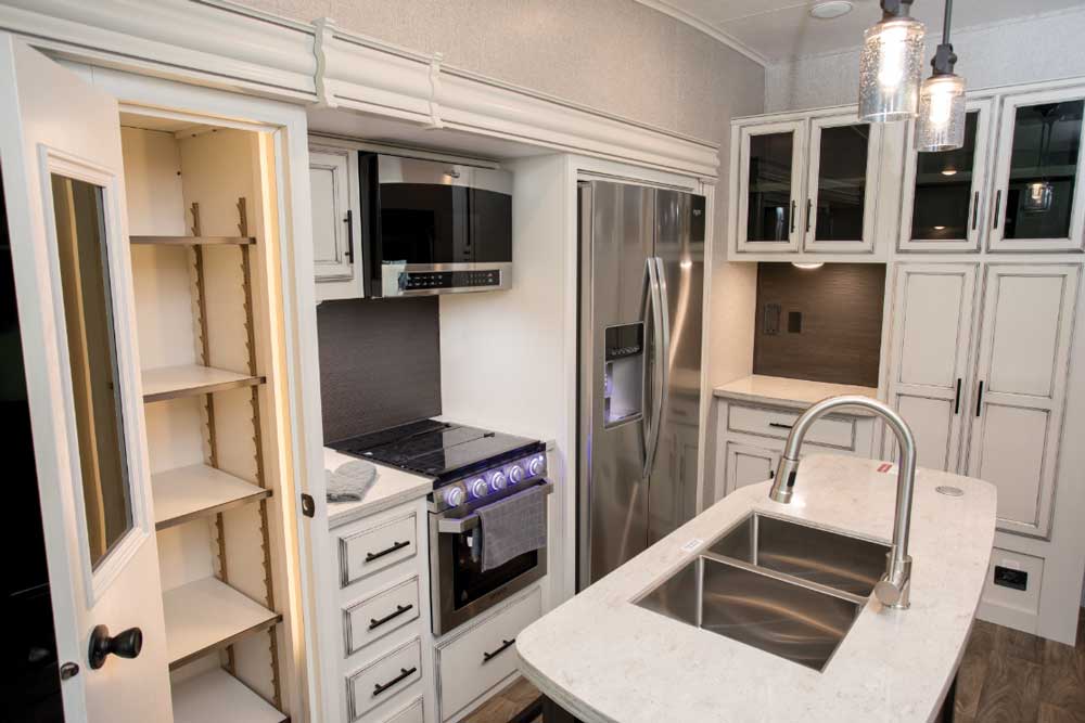 There’s ample counter space and plenty of storage, including a full-door pantry with adjustable shelves that is adaptable for RVers’ personal use and preferences.
