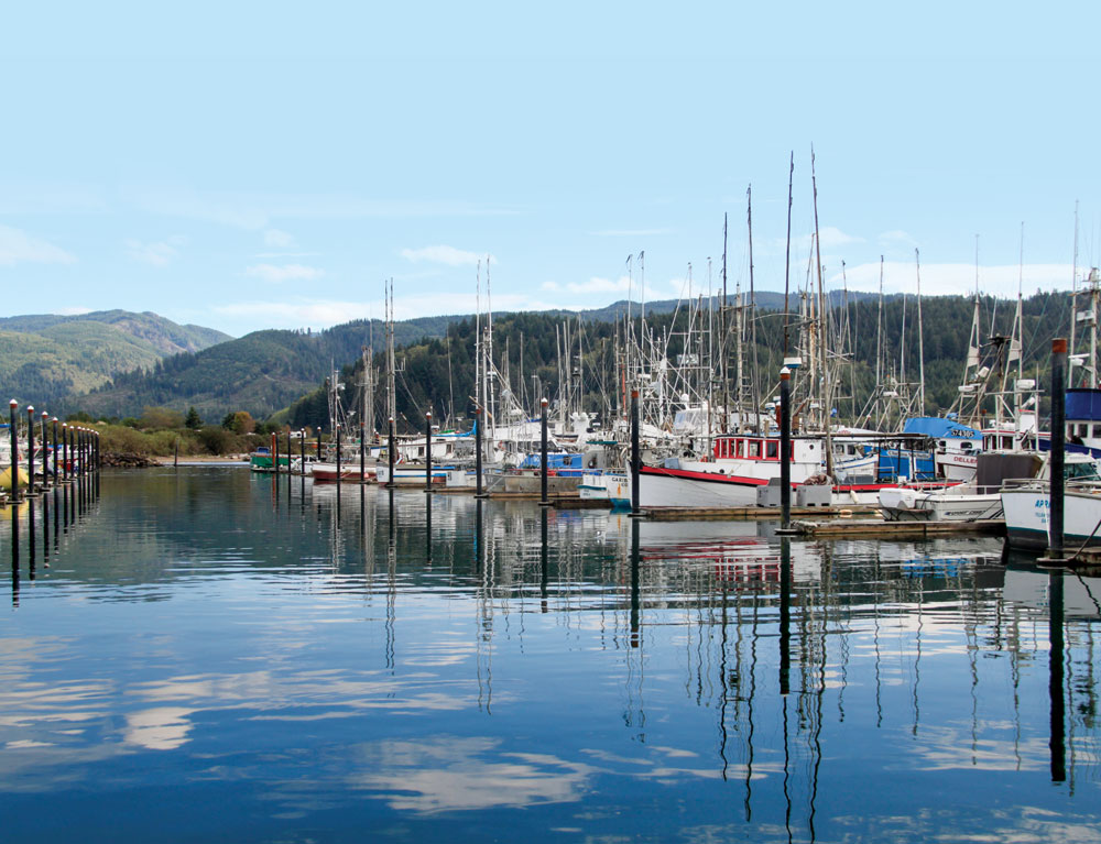Clouds cast reflections in the water at Garibaldi Marina, where you can rent a boat and traps for catching crabs.