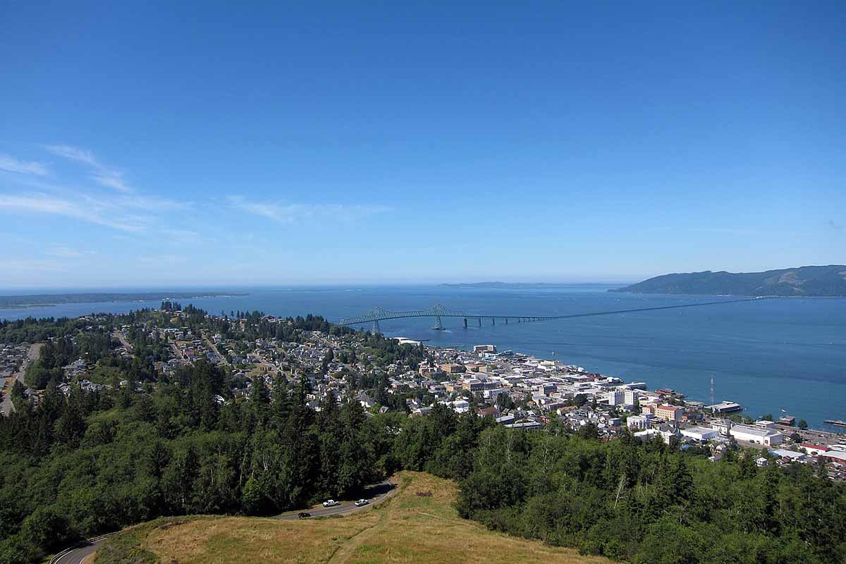 Hilltop view of river mouth and bridge.