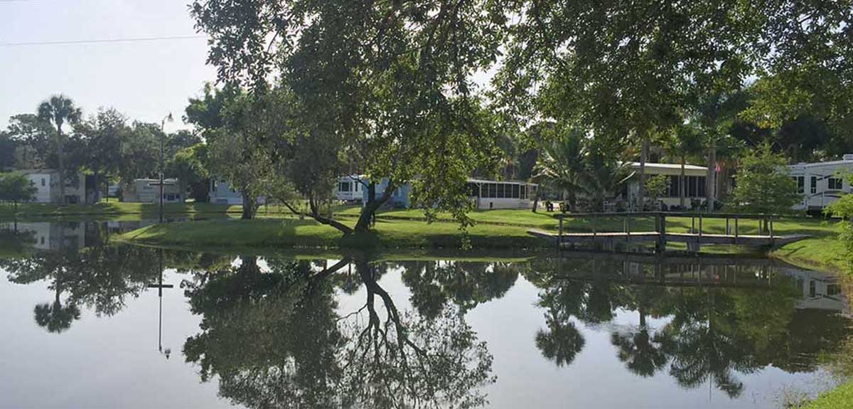 Row of park models overlooking placid pond.