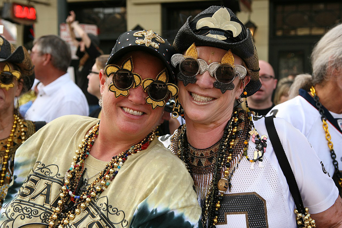 Two women decked out in Saints regalia.