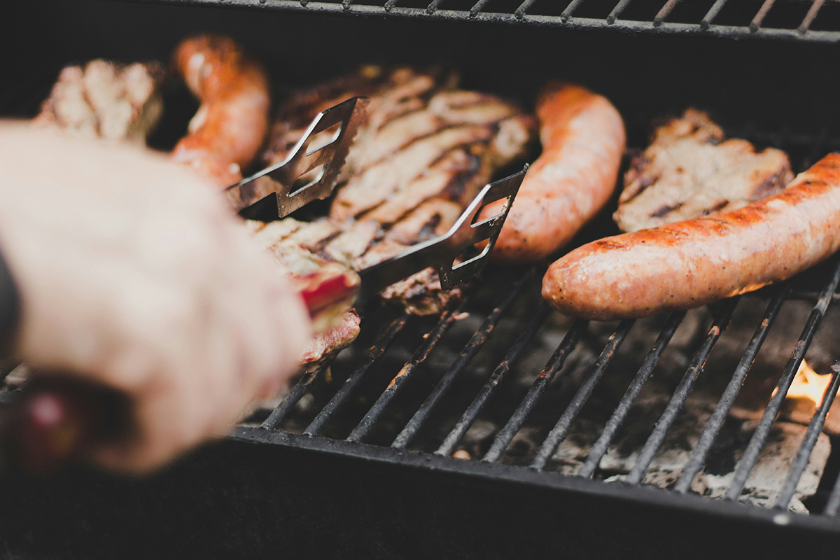 Barbecuing sausages and chicken.