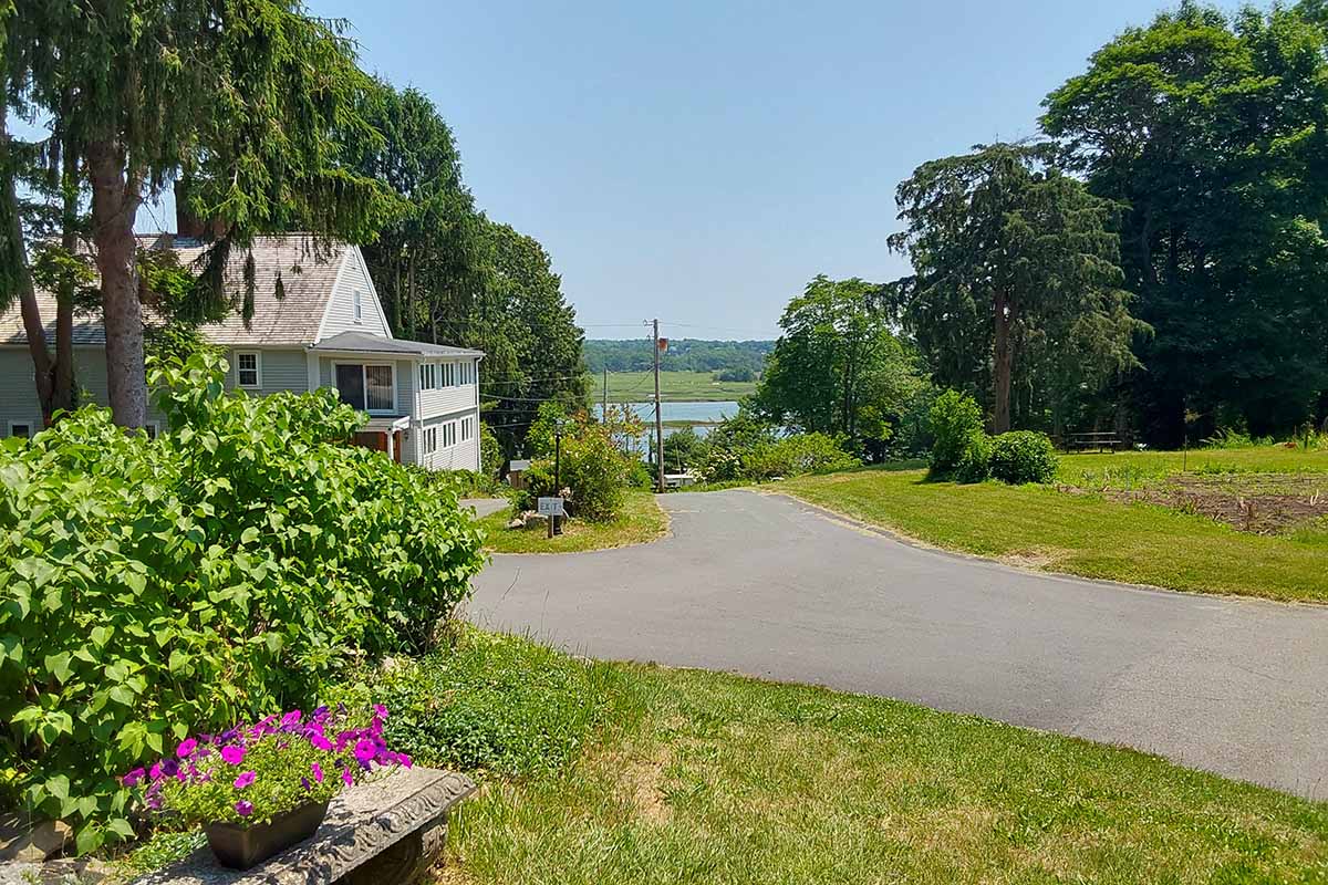 Quaint house with water in background.