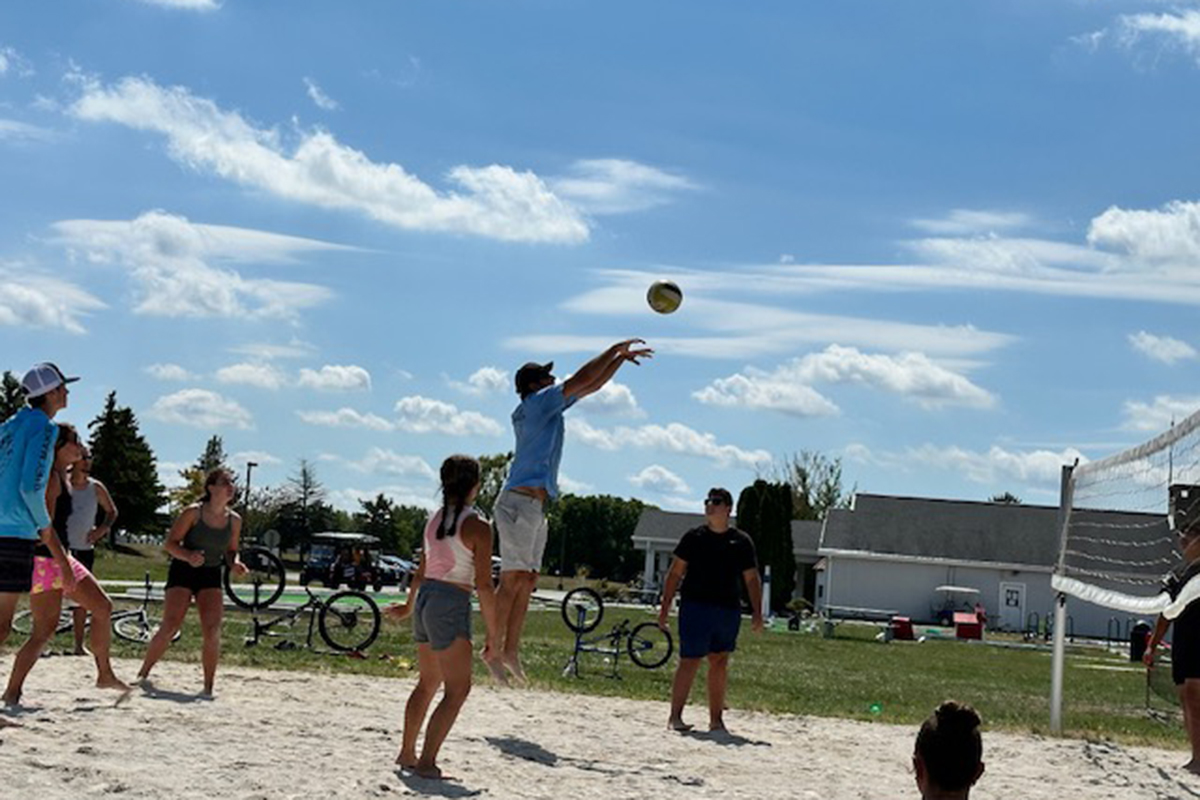 Campers playing volleyball.